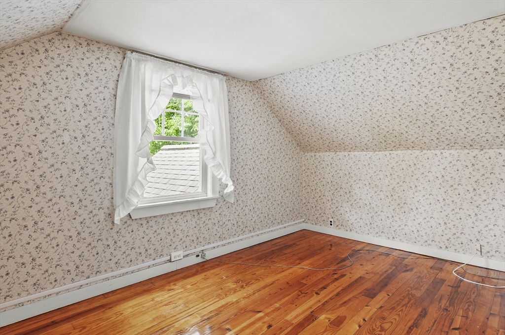 305 Whalom Road Lunenburg, MA 01462 - Photo 24 of 29 a view of empty room with wooden floor and fan