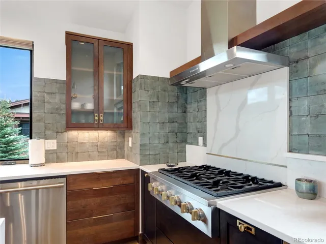a kitchen with stainless steel appliances granite countertop a stove and a sink