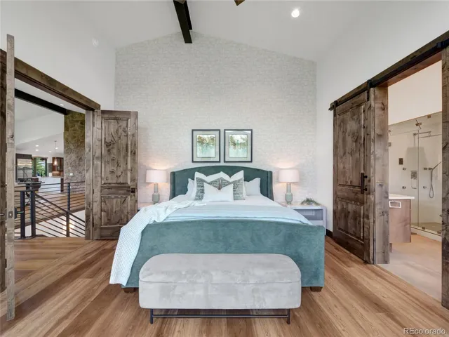 a bed sitting in a bedroom and a table in it