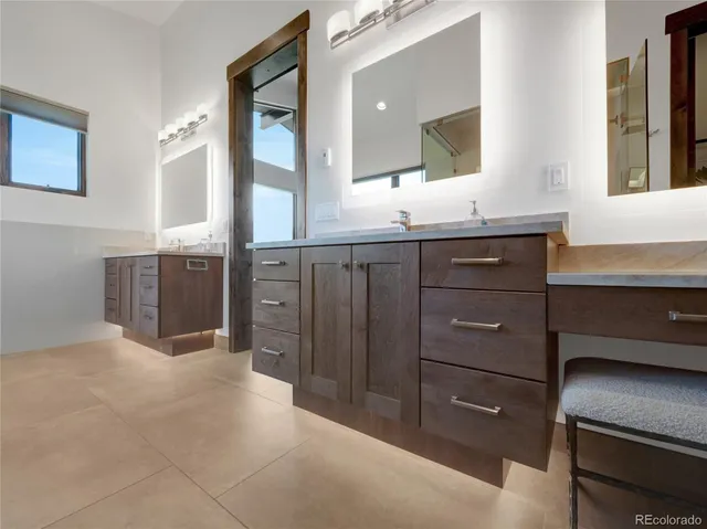 a bathroom with a sink vanity and mirror