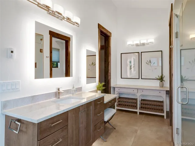 a bathroom with a sink vanity and mirror