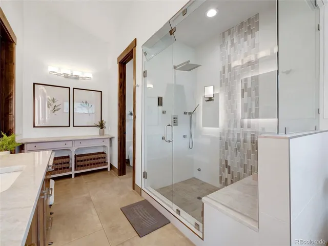 a spacious bathroom with a granite countertop tub sink and shower