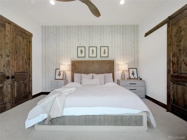 a spacious bedroom with a bed and a window