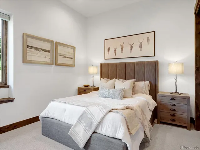 a bedroom with a bed and a painting on the wall