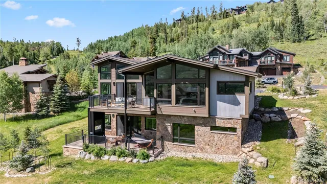 a view of a house with a yard balcony and furniture