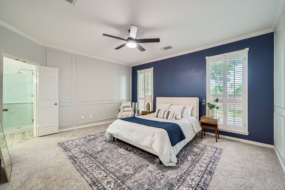 1237 Fall Creek Loop Cedar Park, TX 78613 - Photo 17 of 39 a spacious bedroom with a large bed and a chandelier