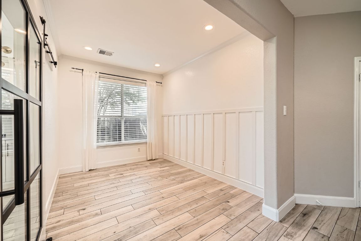 1237 Fall Creek Loop Cedar Park, TX 78613 - Photo 8 of 39 a view of an empty room with wooden floor and a window