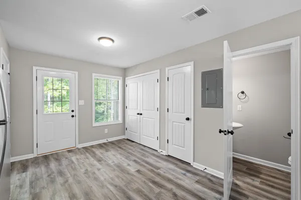 an empty room with windows and closet
