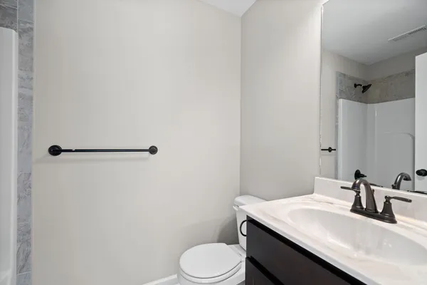 a bathroom with a sink toilet and vanity