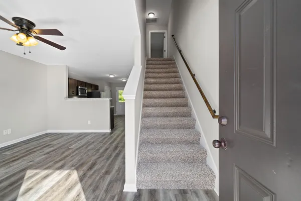 a view of entryway and hall with wooden floor