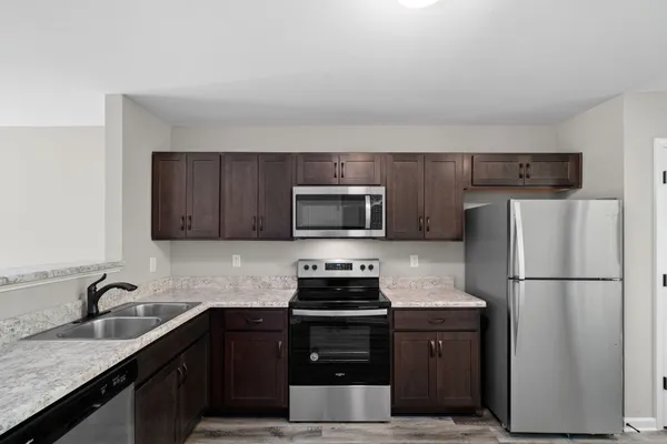 a kitchen with a refrigerator stove and sink