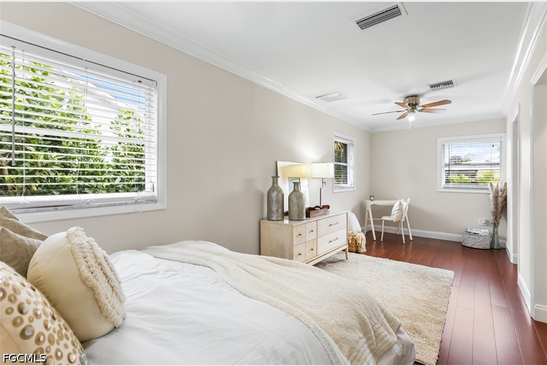 3950 Mohawk Place Naples, FL 34112 - Photo 13 of 25 a bedroom with a bed and wooden floor