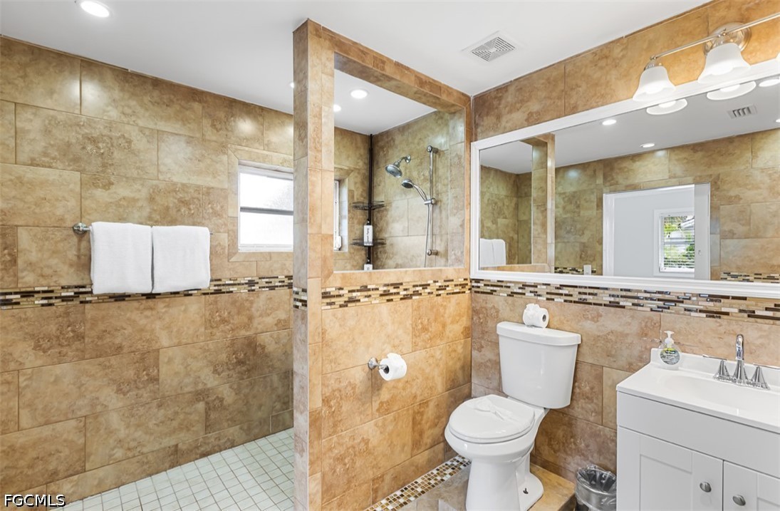 3950 Mohawk Place Naples, FL 34112 - Photo 15 of 25 a bathroom with a toilet sink and mirror