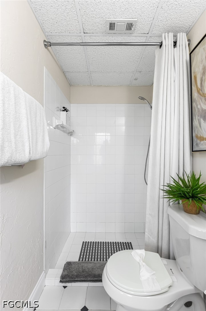 3950 Mohawk Place Naples, FL 34112 - Photo 18 of 25 a white toilet sitting next to a bathroom sink
