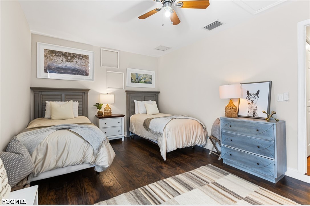 3950 Mohawk Place Naples, FL 34112 - Photo 19 of 25 a bedroom with a bed and wooden floor