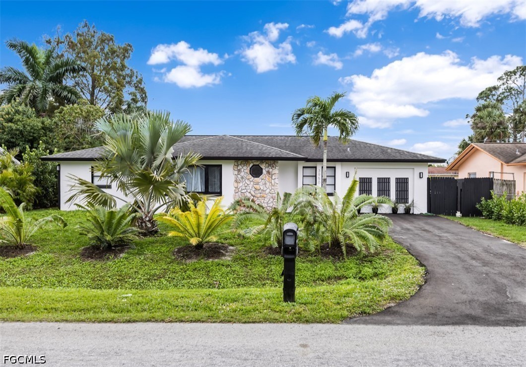 3950 Mohawk Place Naples, FL 34112 - Photo 25 of 25 a front view of a house with garden