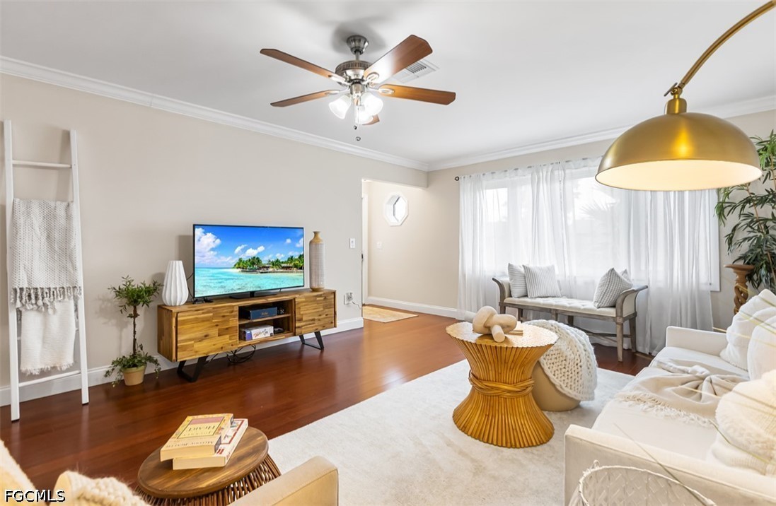 3950 Mohawk Place Naples, FL 34112 - Photo 3 of 25 a living room with furniture a lamp and a flat screen tv