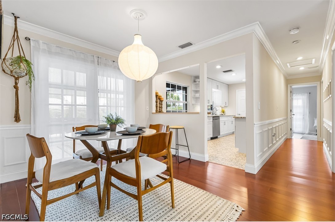 3950 Mohawk Place Naples, FL 34112 - Photo 7 of 25 a view of a dining room with furniture and wooden floor