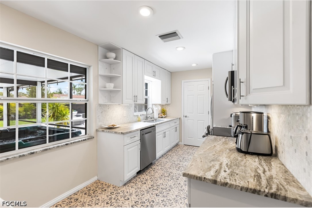 3950 Mohawk Place Naples, FL 34112 - Photo 8 of 25 a kitchen with stainless steel appliances granite countertop a sink stove and cabinets