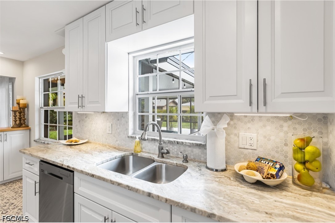 3950 Mohawk Place Naples, FL 34112 - Photo 10 of 25 a kitchen with a sink and cabinets