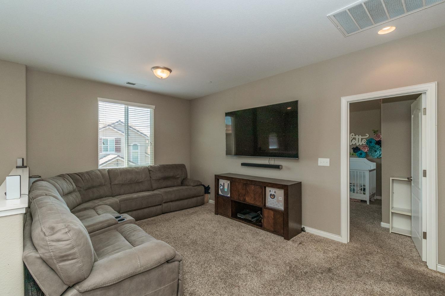3263 Monviso Lane Clovis, CA 93619 - Photo 13 of 30 a living room with furniture and a flat screen tv