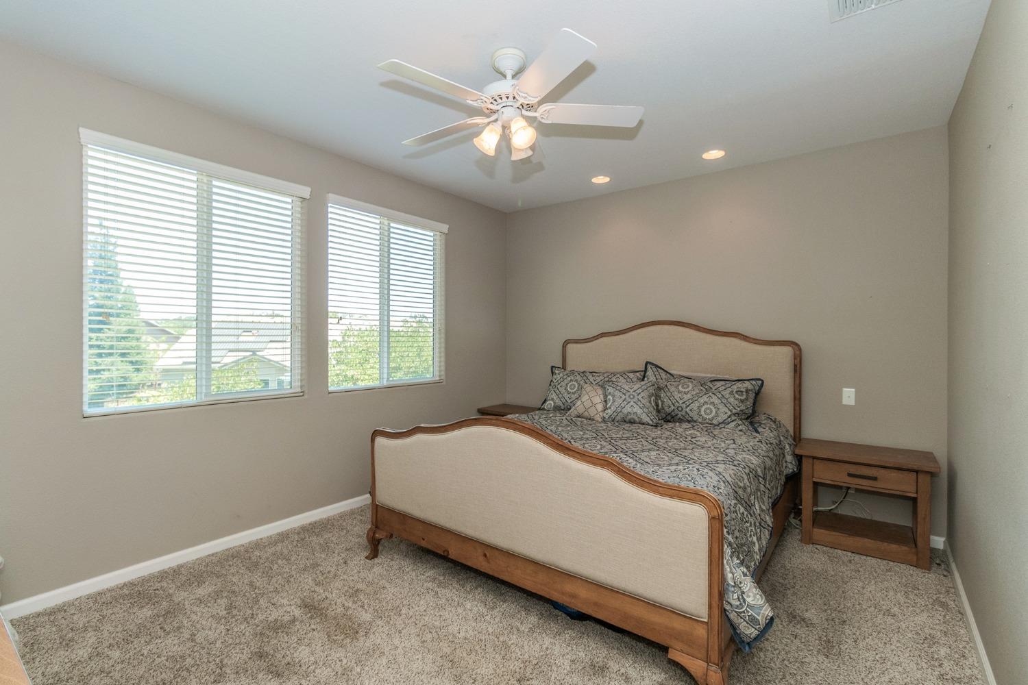 3263 Monviso Lane Clovis, CA 93619 - Photo 14 of 30 a large bed sitting in a bedroom next to a window