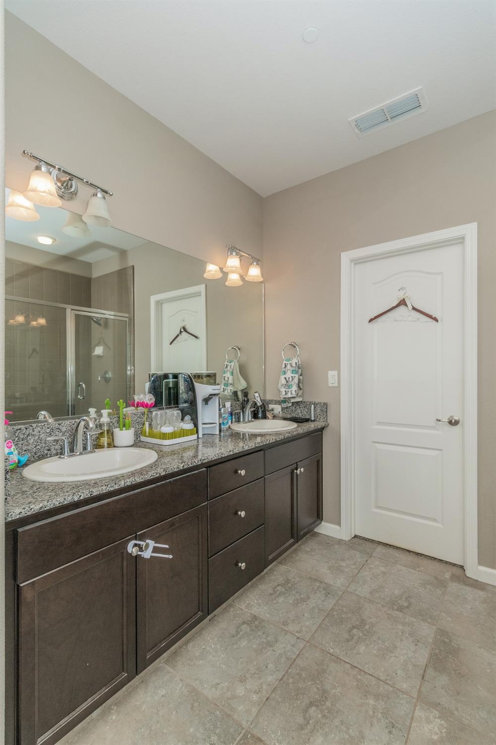 3263 Monviso Lane Clovis, CA 93619 - Photo 16 of 30 a bathroom with a granite countertop sink and a mirror