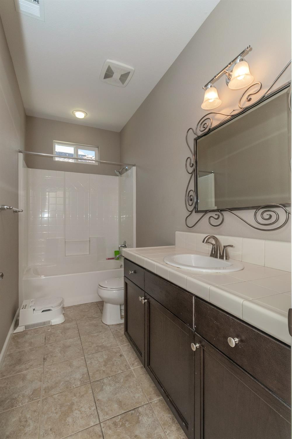 3263 Monviso Lane Clovis, CA 93619 - Photo 19 of 30 a bathroom with a double vanity sink toilet and shower