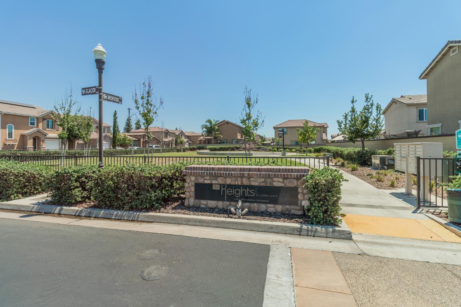 3263 Monviso Lane Clovis, CA 93619 - Photo 25 of 30 a front view of a building with an outdoor space and seating area