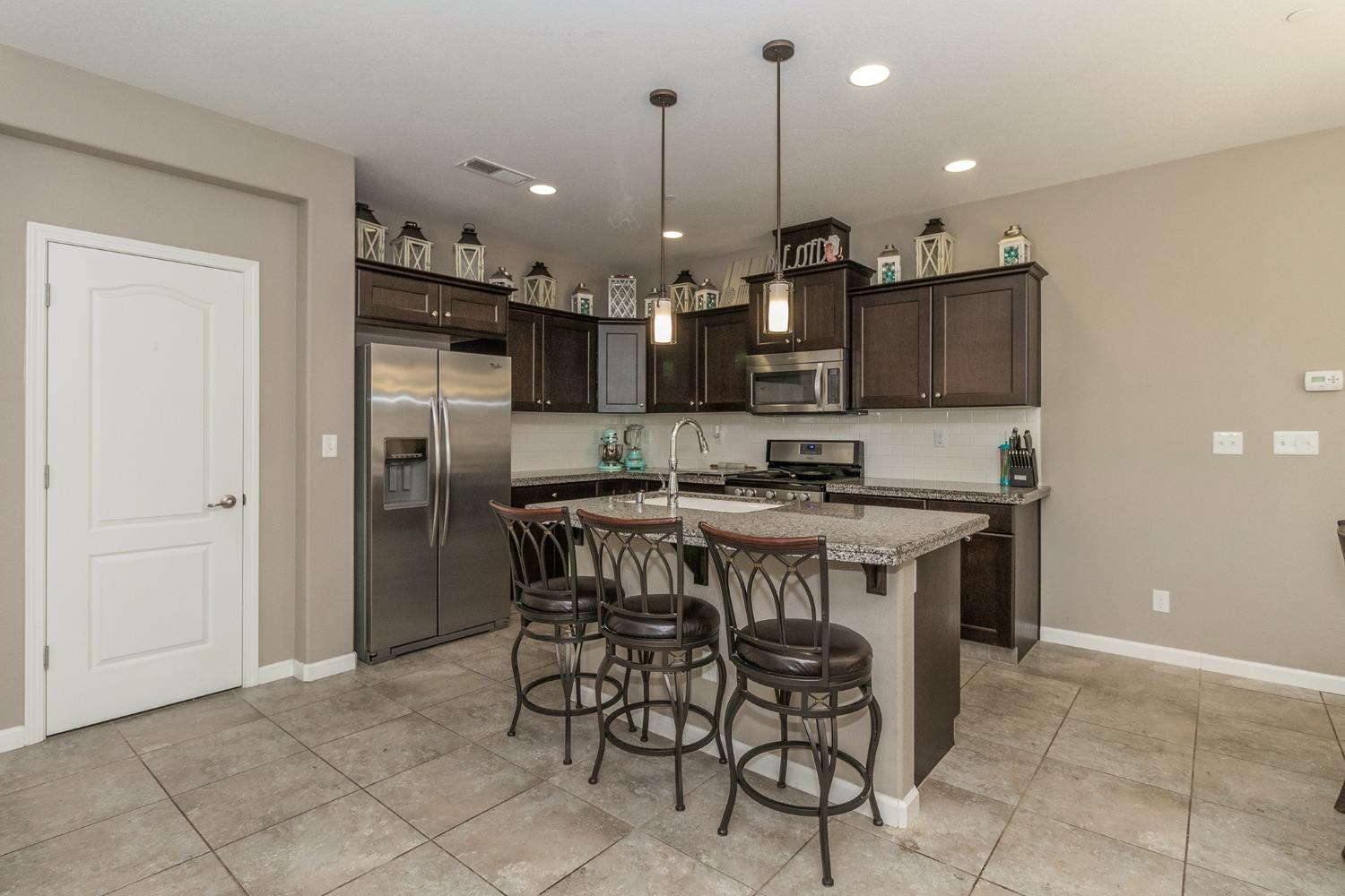3263 Monviso Lane Clovis, CA 93619 - Photo 7 of 30 a kitchen with a table and chairs in it