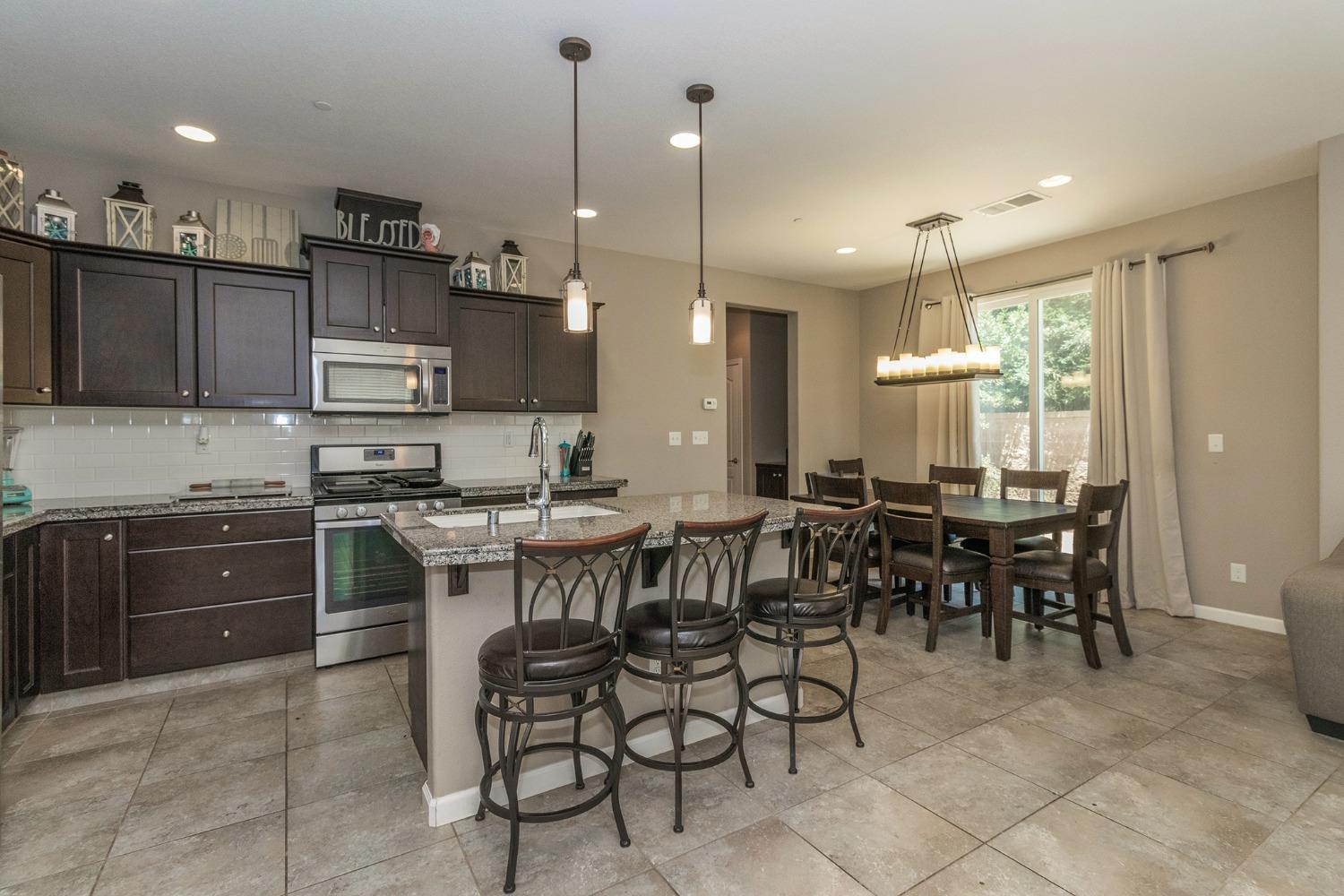 3263 Monviso Lane Clovis, CA 93619 - Photo 8 of 30 a large kitchen with a table and chairs