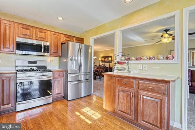 a kitchen with stainless steel appliances a stove microwave and refrigerator