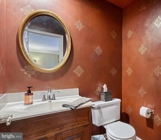 a bathroom with a toilet sink and mirror