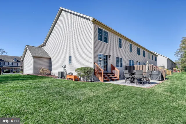 a front view of house with yard and outdoor seating