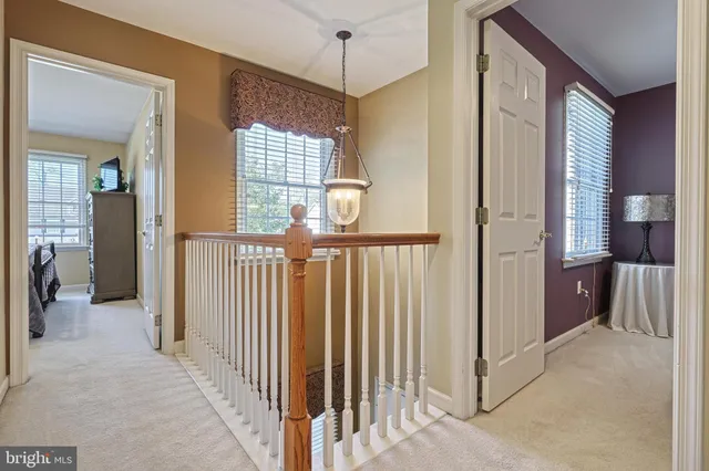 a view of a hallway with a chandelier and livingroom