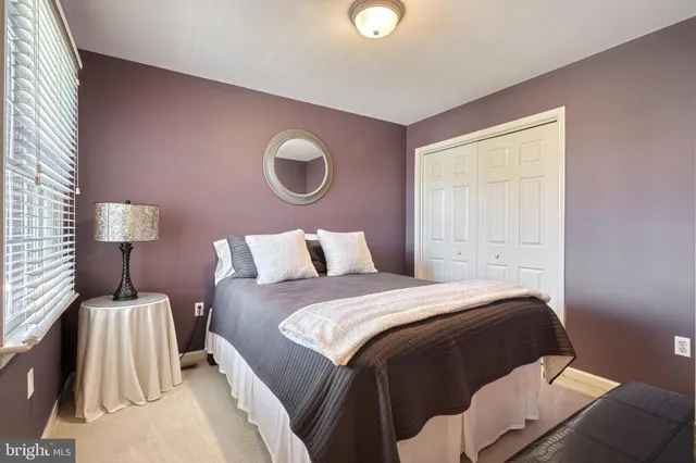 a bed room with a bed and a lamp