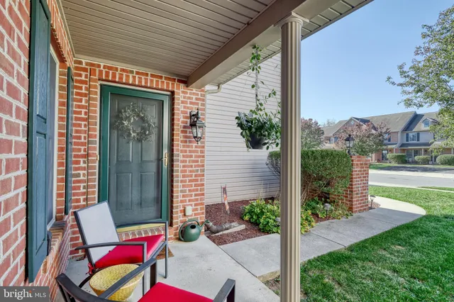 a view of porch with a bench and floor to ceiling window