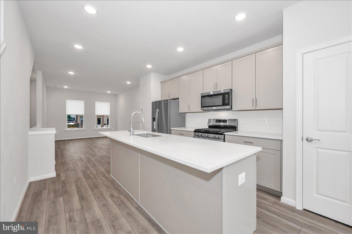 3357 Cormorant Drive Laurel, MD 20724 - Photo 11 of 41 a kitchen with a sink a counter top space stainless steel appliances and cabinets