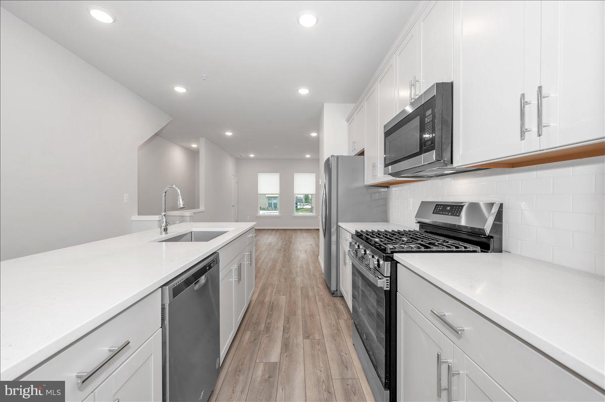 3357 Cormorant Drive Laurel, MD 20724 - Photo 14 of 41 a kitchen with a sink stove top oven and cabinets