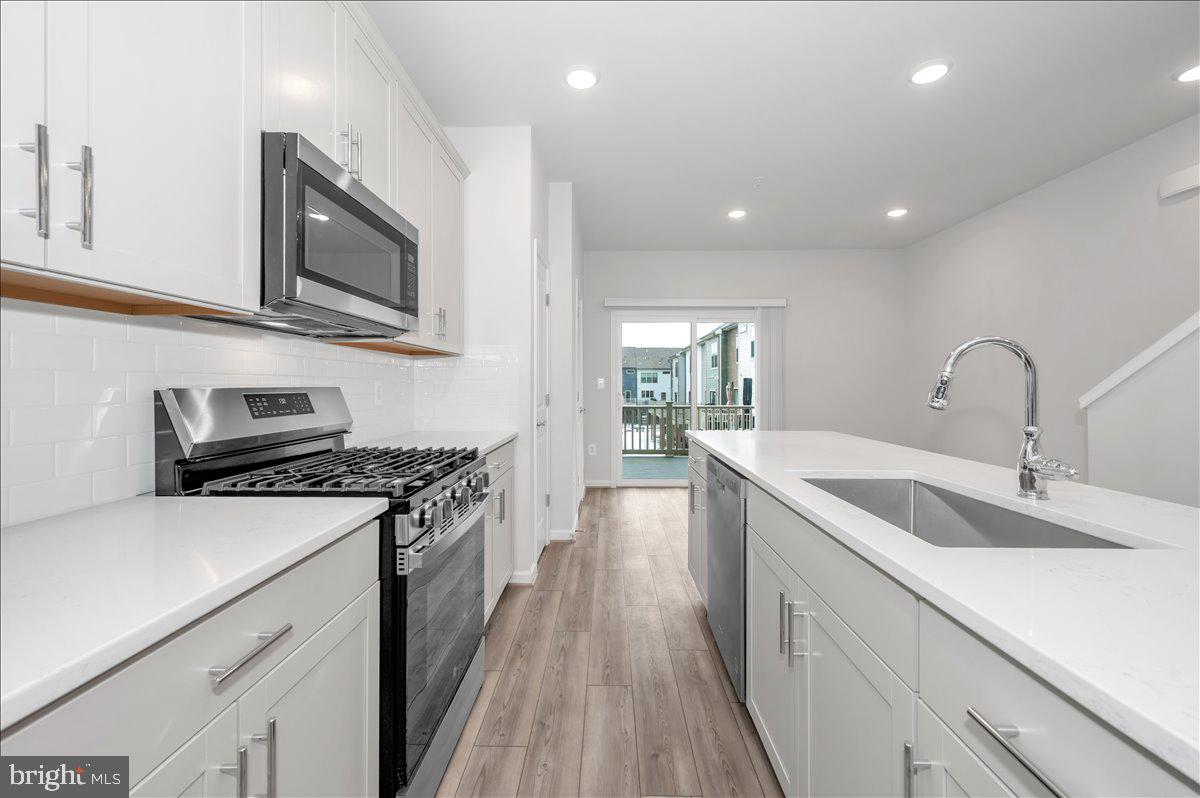 3357 Cormorant Drive Laurel, MD 20724 - Photo 15 of 41 a kitchen with stainless steel appliances granite countertop a sink stove and microwave