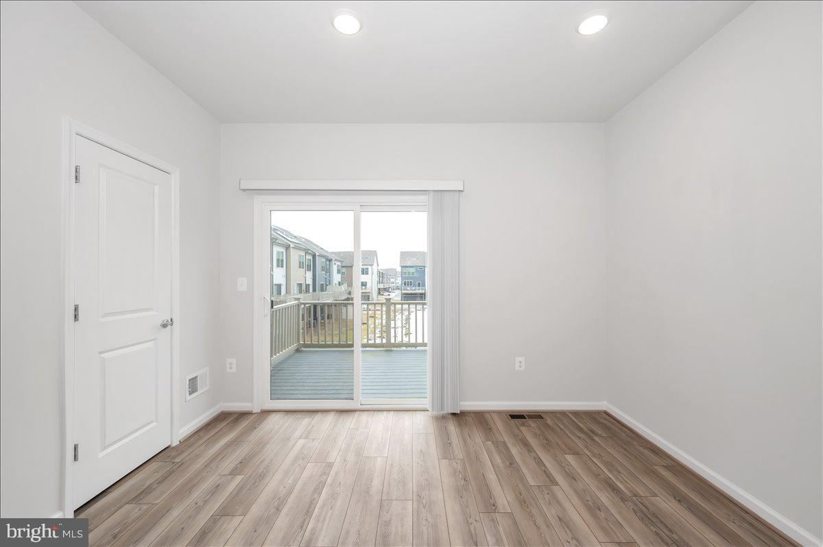 3357 Cormorant Drive Laurel, MD 20724 - Photo 17 of 41 an empty room with wooden floor and windows