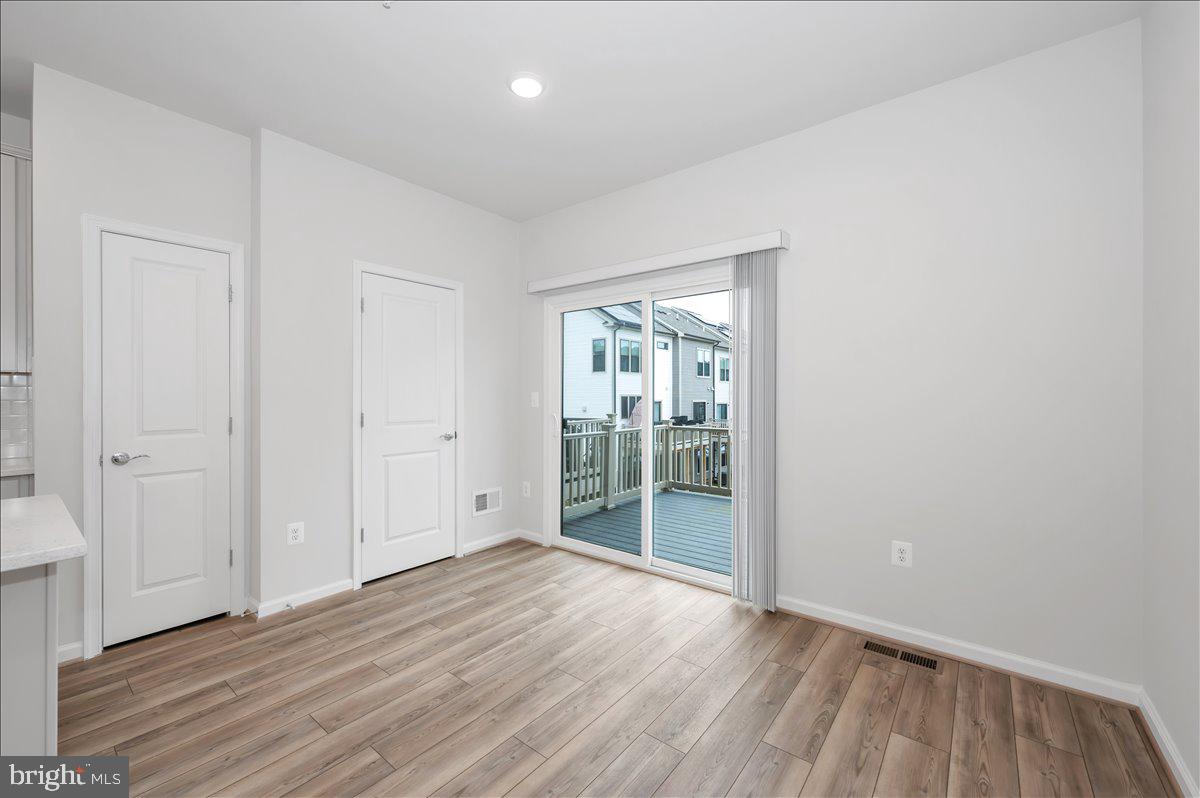 3357 Cormorant Drive Laurel, MD 20724 - Photo 18 of 41 an empty room with wooden floor and windows