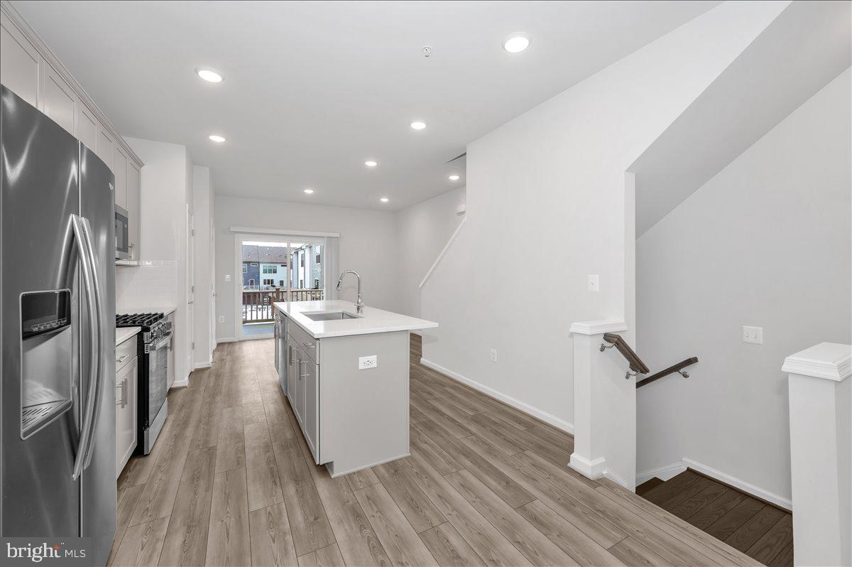 3357 Cormorant Drive Laurel, MD 20724 - Photo 8 of 41 a kitchen with stainless steel appliances granite countertop a refrigerator a sink and wooden floor