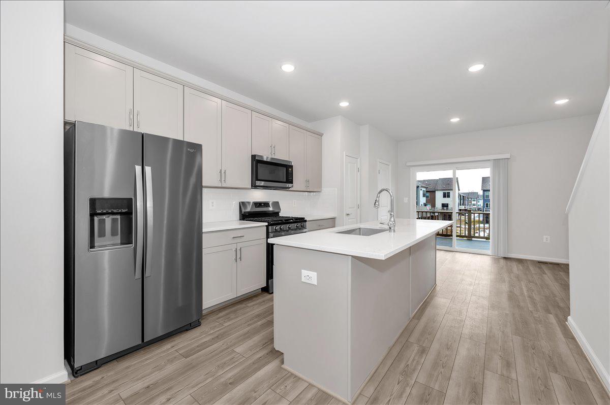 3357 Cormorant Drive Laurel, MD 20724 - Photo 10 of 41 a kitchen with a sink a refrigerator and cabinets