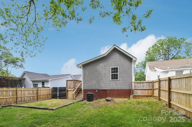 a view of backyard with a garden and deck