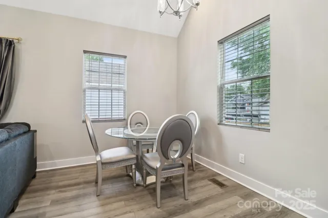 a dining room with furniture a window and wooden floor