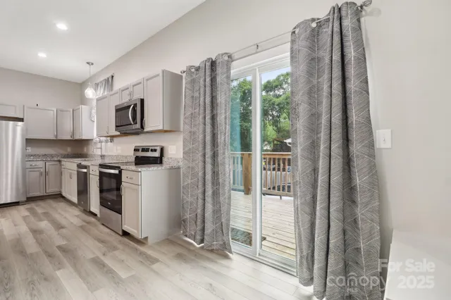 a kitchen with stainless steel appliances a refrigerator and a stove top oven