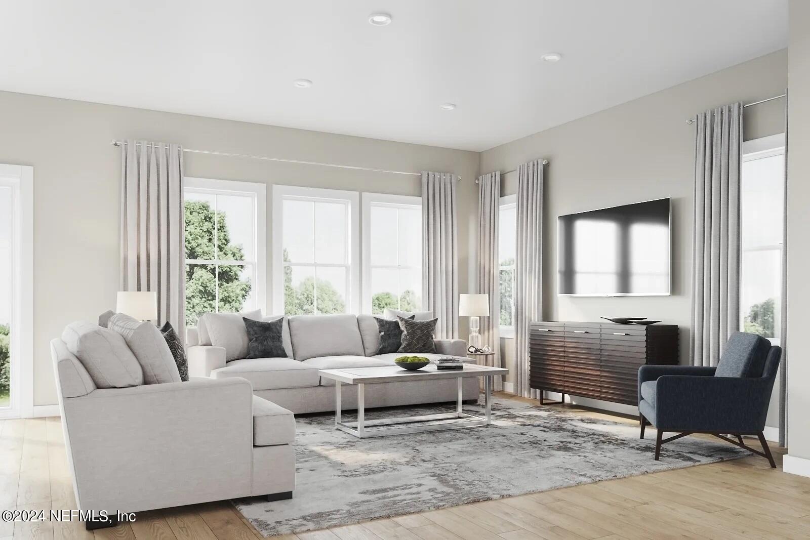 32 Yellowstone Drive, Unit 1001C St. Augustine, FL 32092 - Photo 2 of 6 a living room with furniture and large windows