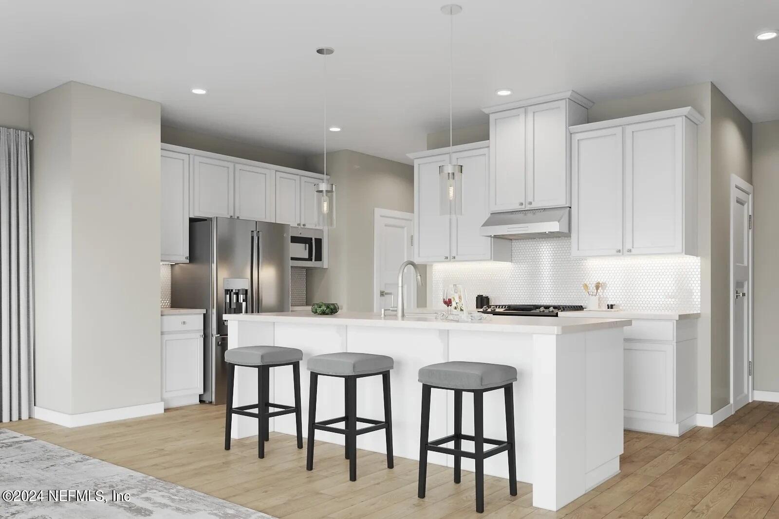 32 Yellowstone Drive, Unit 1001C St. Augustine, FL 32092 - Photo 4 of 6 a kitchen with stainless steel appliances granite countertop a stove a refrigerator a white table and chairs