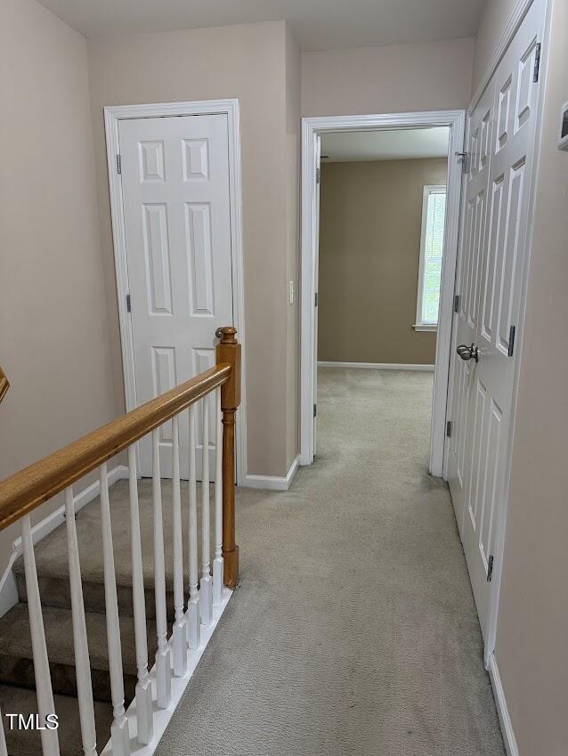 4429 Log Cabin Drive Raleigh, NC 27616 - Photo 16 of 27 a view of a hallway with wooden floor and a bathroom